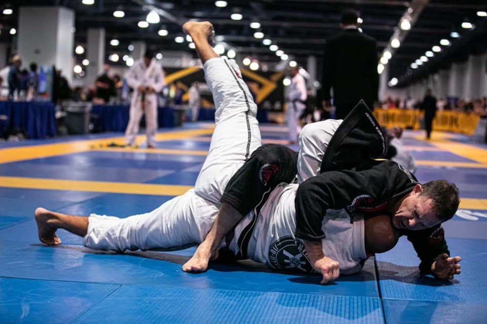 Luke Harris goes for the pin on Cristiano Ribeiro da Costa in their championship bout at the World Masters Jiu-Jitsu event in Las Vegas on Nov. 13, 2021. GISELLE VILLASENOR/Photo