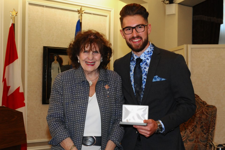 Alberta Lt.-Gov. Lois Mitchell congratulates St. Albert's Garrett Gerrard after he was presented with the QEII Golden Jubilee Citizenship Medal on Tuesday. OFFICE OF THE LIEUTENANT GOVERNOR OF ALBERTA/Photo