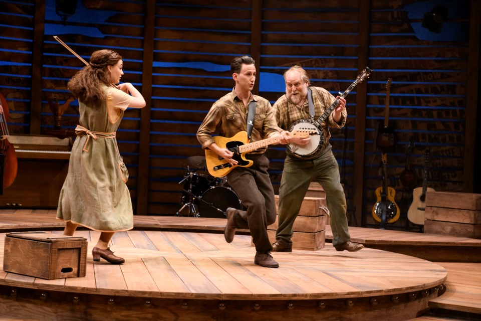 Lawrence Tibor (centre) as a young Johnny Cash sings about early life on the Cash family's Alabama cotton farm. Flanking hiim are Quinn Dooley (left) on fiddle and Julien Arnold playing banjo. IAN JACKSON; EPIC PHOTOGRAPHY/Photo