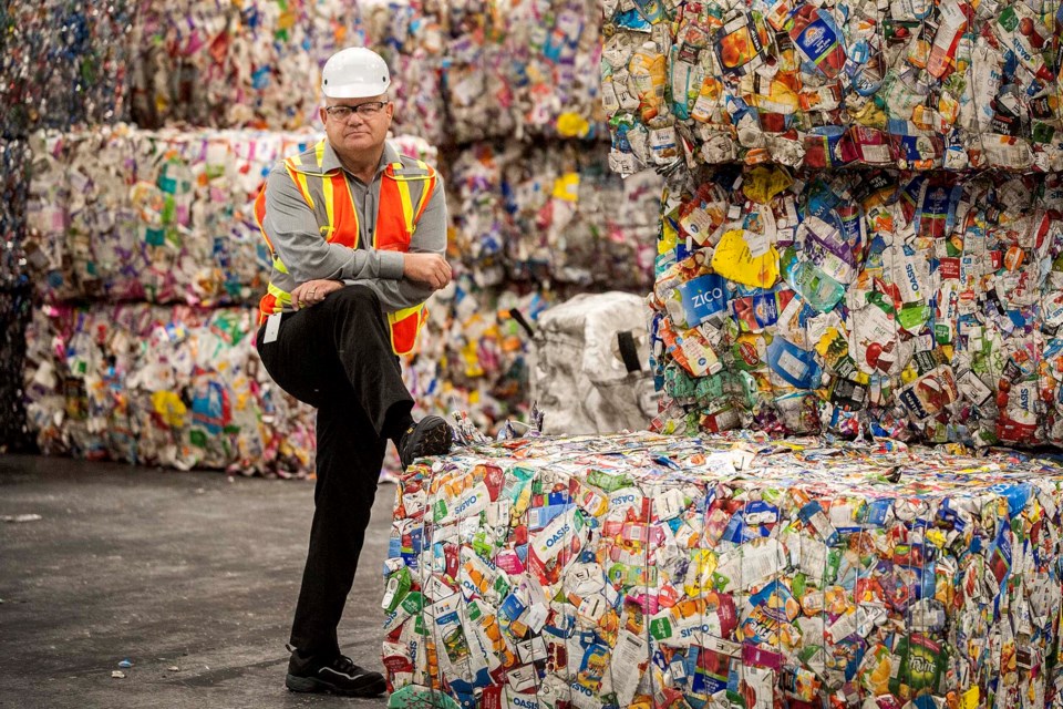 VALUABLE STUFF – Guy West, president of the Alberta Beverage Container Recycling Corporation, says recyclable items such as these tetra packs are valuable, but only if properly sorted. Alberta's producer-funded bottle depot system is designed to ensure pure streams of material that can easily be baled for sale. 