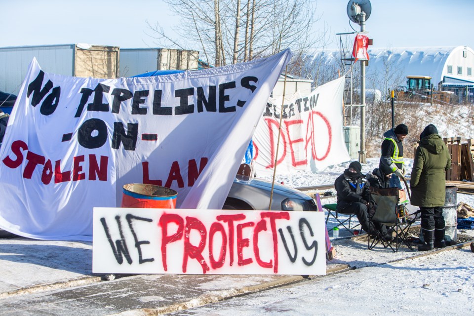 Protesters convereged on a CN Rail line west of Edmonton in the early hours of Wednesday and set up a blockade of wood and barrels to show solidarity with the  Wet’suwet’en hereditary chiefs and fellow protesters who are currently embroiled in a battle with RCMP and the Coastal GasLink project on First Nations territory in B.C. CHRIS COLBOURNE/St. Albert Gazette