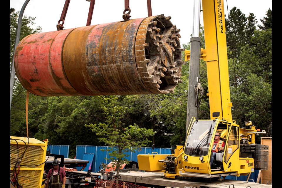 Jesse Evans, a contracted Project 9 crane operator, lifts a Tunnel Boring Machine from a flatbed truck to the access hole at the Sturgeon Rd. and Burnham Ave. location of Phase 3's Project 9 North Interceptor Sanitary Trunk in July 2018. DAN RIEDLHUBER/St. Albert Gazette