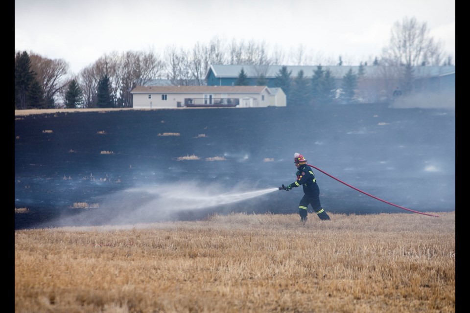 The City of St. Albert Fire and Rescue Services responded to a grass fire along Meadowview Dr. on Wednesday afternoon. Crews put the fire out quickly and used water to tackle potential hotspots from flaring up again. CHRIS COLBOURNE/St. Albert Gazette