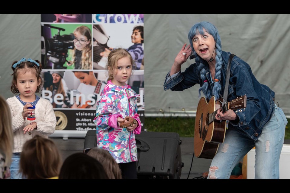 Martha Messmaker had some help from (L-R) Samantha Hofer 4 and  Leah Aberle 6 , during the International Children's Festival of the Arts in St Albert on Thursday June 1, 2023. (JOHN LUCAS/St Albert Gazette)