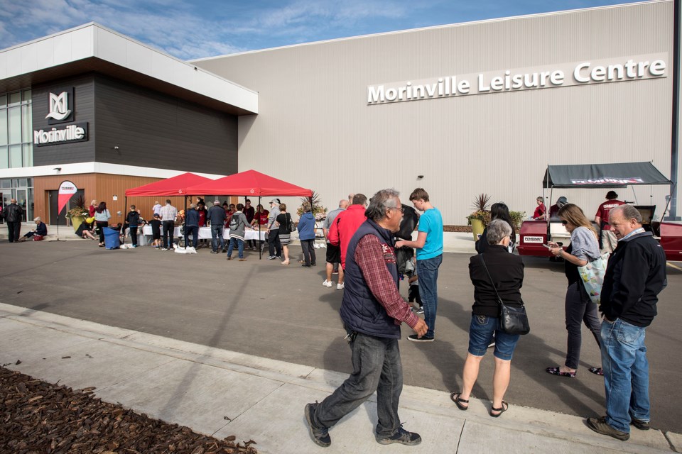 Patrons line up to take advantage of the free barbecue.  DAN RIEDLHUBER/St. Albert Gazette