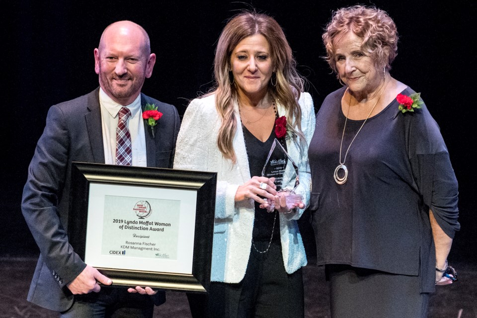 Rosanna Fischer, centre, of KDM Management Inc., receives the Lynda Moffat Woman of Distinction award from Lynda Moffat, right, and Mark Stoneleigh, Chamber of Commerce chair.  DAN RIEDLHUBER/St. Albert Gazette