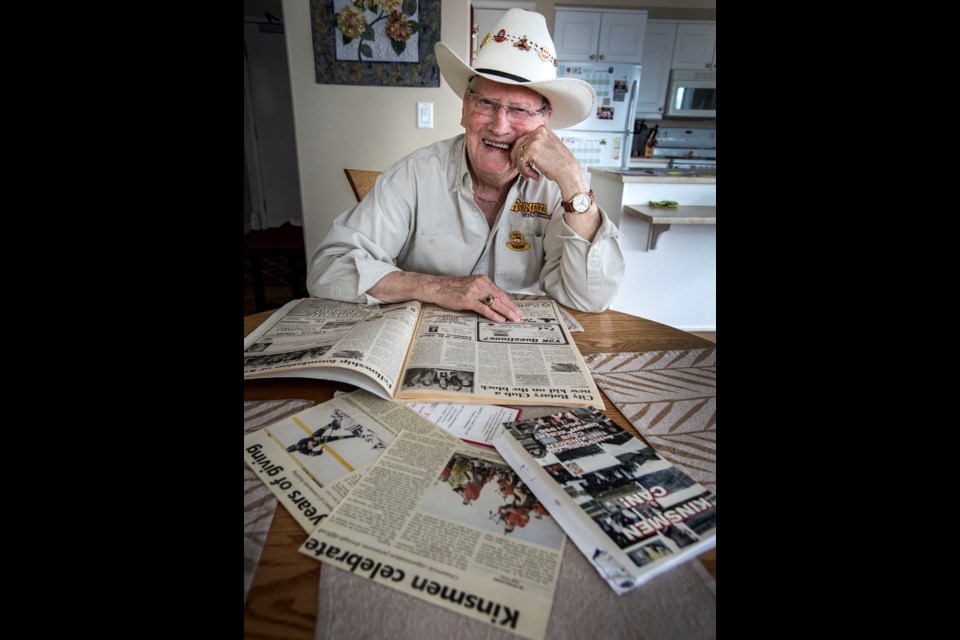 KINSMAN COWBOY - Bill Hite, 85, one of the original 14 St. Albert Kinsmen Club members who helped organize the first rodeo in St. Albert, looks over some the Kinsmen memorabilia in his collection. The 55th annual Rainmaker Rodeo goes this weekend at Riel Recreation Park.