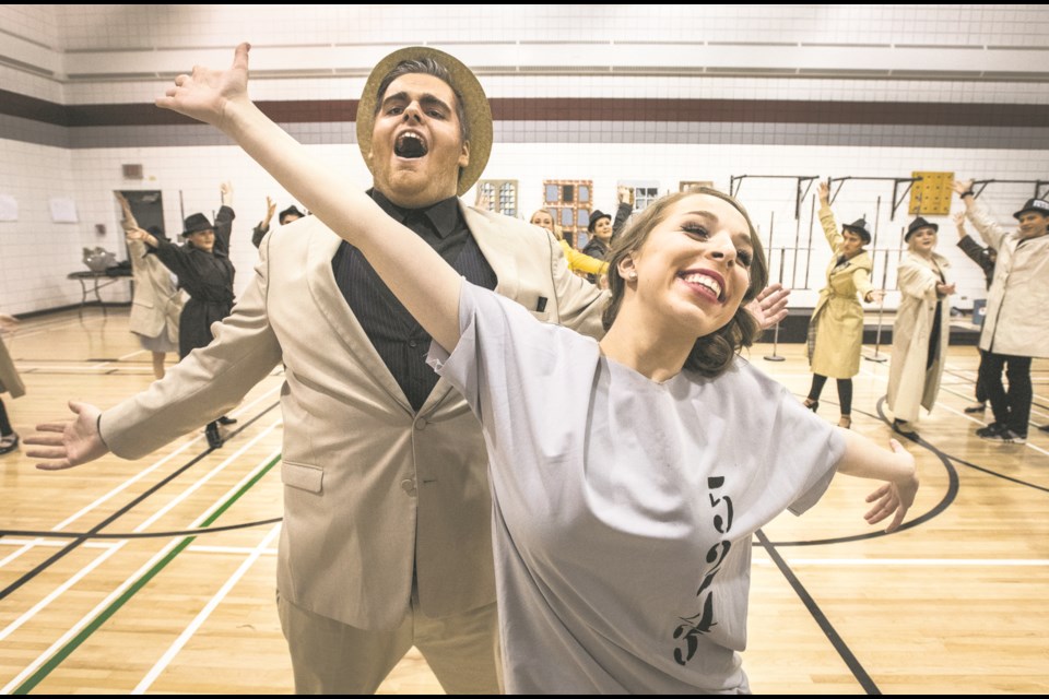 Connor Greenough as Billy Flynn, left, and Sarah Johnson as Roxie rehearse their roles in the musical stage production of Chicago with fellow Bellerose Composite High School players on Jan. 31. Both Greenough and Johnson have been nominated for Cappie awards.