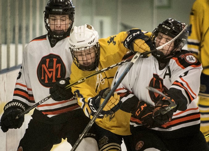 SQUISHED – Carter MacDonald of the St. Albert Source for Sports Crusaders is sandwiched between Carsyn Good, left, and Levi Schlosser of the Medicine Hat Hounds at the provincial midget AA tournament Saturday at The Meadows Community Recreation Centre. MacDonald scored in the come-from-behind 2-1 decision as the Crusaders finished the round robin in a three-way tie with Medicine Hat and CNHA Canucks at 3-1. Sunday’s bronze playoff victory for the Crusaders was 4-1 over the Canadian Athletic Club. The Crusaders start the Northern Alberta Midget AA Hockey League best-of-five final Thursday against the Camrose Vikings at 8:15 p.m. at Akinsdale Arena.
DAN RIEDLHUBER/St. Albert Gazette