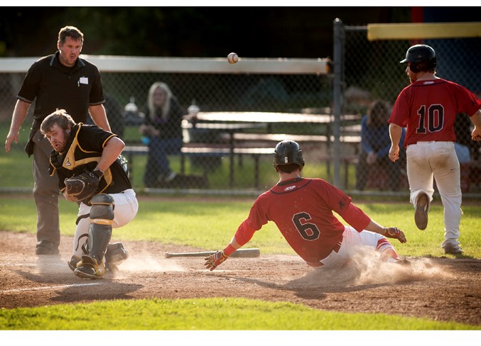 ARRIVING HOME – Zach Pollard (10) and Hayden Chies score as the throw from the outfield gets away from catcher Matt Orey of the Edmonton Primeaus in the North Central Alberta Baseball League game Tuesday at Legion Memorial Park. A triple off the bat of Tanner McLean-Poll produced the RBIs in the 7-5 win. Wednesday the Cardinals beat the host Stony Plain Mets 4-3 and Thursday's 7-4 decision against the Parkland Twins in St. Albert was the sixth victory in a row for the third-place Cardinals (11-6-1). 
DAN RIEDLHUBER/St. Albert Gazette