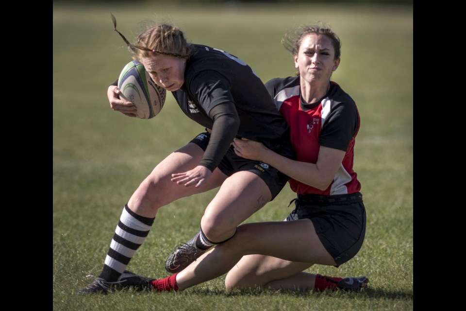 ABRUPT STOP – Drew Baldwin of the Sturgeon Spirits wraps up Sydney Gallagher of the Jasper Place Rebels in Monday's metro Edmonton division one women’s final at Ellerslie Rugby Park. The entertaining back and forth affair ended with the undefeated Rebels scoring multiple tries to close out the fourth quarter for the 53-34 victory as Sturgeon finished league play with a record of 5-3.  
DAN RIEDLHUBER/St. Albert Gazette