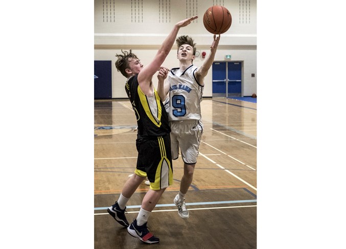 LETTING LOOSE – Carter Walter of the Paul Kane Blues attempts to slip a shot past Cole Minchington of the Archbishop Jordan Scots in Saturday’s metro Edmonton division two junior men’s final at Ross Sheppard. The Scots knocked off last year’s champions 68-56.
DAN RIEDLHUBER/St. Albert Gazette