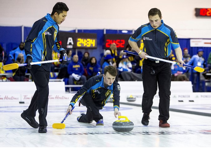 SHOT MAKER – Ben Helston releases a rock for Morgan Bilassy, left, and Nick Warkman of the Nathan Molberg rink of St. Albert at the third annual Curling Canada U18 championships at Glen Allan Recreation Complex in Sherwood Park. In pool B of the 14-team men’s draw, Team Alberta was ranked first at 4-1 with one game left Friday before advancing to the eight-team double-knockout championship round today to determine Sunday’s medal finals. Visit www.curling.ca for draw times and results.
CHRIS COLBOURNE/St. Albert Gazette