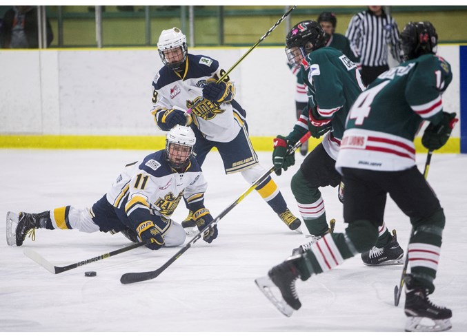 PLAYING THE PUCK – Marko Stolic makes a play while down on the ice for the St. Albert Gregg Distributors Sabres with teammate Aidan Taylor and SSAC Southgate Lions’ Joel Green and Cade Christenson, right, near the puck in Wednesday’s nitro north division final in the Alberta Major Bantam Hockey League. SSAC won game two 7-4 at Akinsdale Arena after losing Monday’s best-of-three series opener 5-2 at Millwoods Arena. Game three was Thursday’s 2-1 series clincher by SSAC at Callingwood Arena. 
CHRIS COLBOURNE/St. Albert Gazette