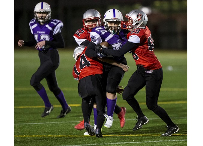 SIEZED – Julia Baniak of the St. Albert Valkyries is wrapped up by the West Edmonton Raiders, as teammate Emily Maki looks on in the background, during the Capital District Minor Football Association’s inaugural midget female six-on-six game Friday at Clarke Stadium. The Valkyries won 20-19. The next game in the four-team league is 9:15 p.m. Friday against the Leduc Wildcats at Clarke Stadium.
CHRIS COLBOURNE/St. Albert Gazette