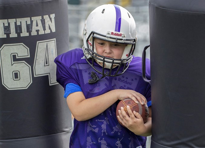 STRAIGHT AHEAD – Max Sponchia, 10, a returning player on the Vikings, punches through a set of tackle dummies during the first practice of the season Wednesday at Larry Olexiuk Field. The Vikings, Jaguars and Buccaneers are the St. Albert Minor Football Association atom teams in the Capital District Minor Football Association.
CHRIS COLBOURNE/St. Albert Gazette