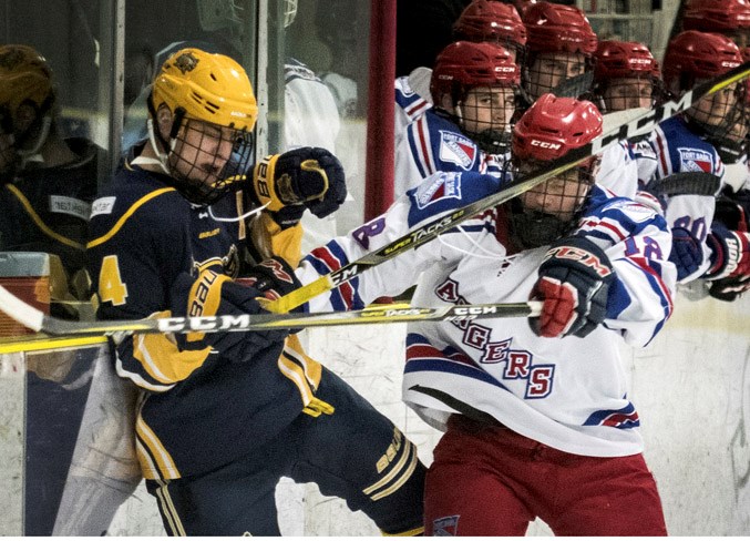 KABOOM – Matthew Rathbone, left, of the St. Albert Nektar Raiders and Daniel Keys of the Fort Saskatchewan Rangers crash and bang along the boards Wednesday in game three of the best-of-five north division final in the Alberta Midget AAA Hockey League at Akinsdale Arena. The Raiders won 3-1 after overtime losses of 4-3 in the first extra period and 3-2 in the third OT frame. Game four was played Friday in Fort Saskatchewan and the score was unavailable at press time. If needed, game five is 7:30 p.m. Sunday at Akinsdale.
DAN RIEDLHUBER/St. Albert Gazette