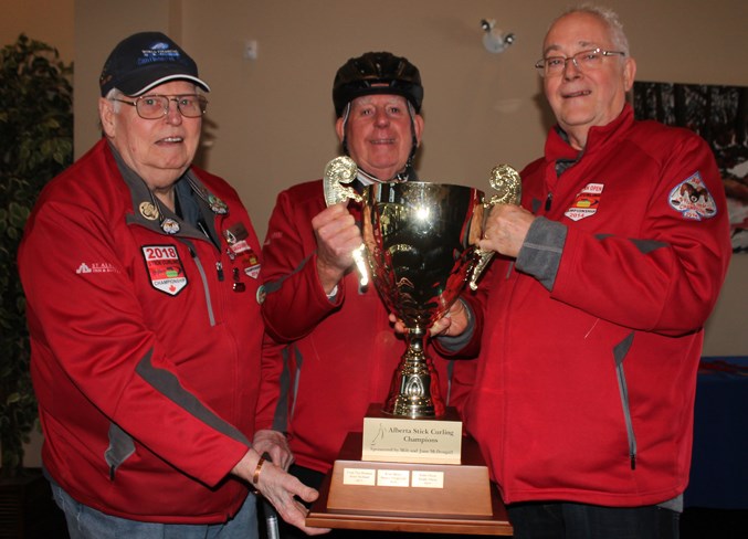 PROVINCIAL CHAMPIONS – Milt McDougall, right, of St. Albert, presents the Alberta Stick Curling Champions trophy, sponsored by McDougall and his wife, June, to Bob Lee and Bob McKenzie after Sunday's final at the provincial two-person open competition at St. Albert Curling Club. The St. Albert duo blanked Larry and Judy Lafleur of Edmonton 3-0 in six ends and will represent Alberta at nationals in April at Regina. The Lafleurs also curl out of St. Albert. McKenzie and McDougall were the 2014 Sturling provincial two-person champions in 2014.   
JEFF HANSEN/St. Albert Gazette