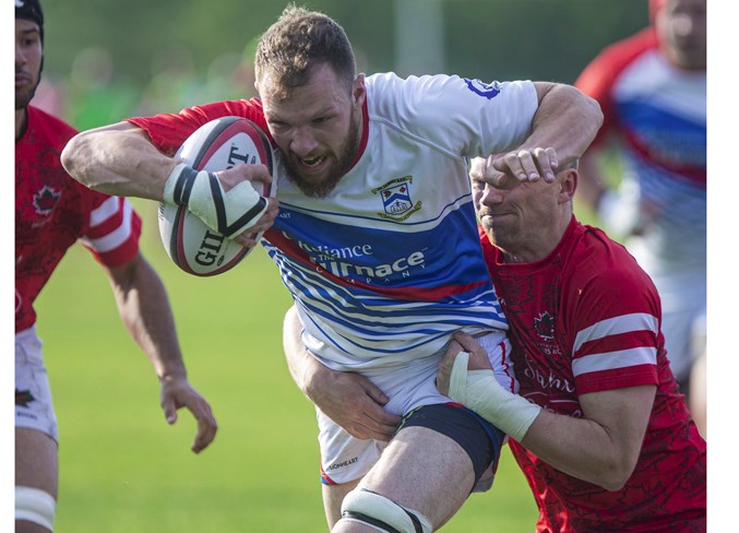 GAINING GROUND – Orrin Farries of the St. Albert Rugby Football Club pushes forward with a Strathcona Druid in tow during the Alberta Cup premier men's match Friday at Lynn Davies Rugby Park. Brian Fitzpatrick's penalty kick with around 10 minutes remaining broke a 19-19 deadlock as the defending Labatt's Cup provincial champions rallied from 14 point second-half deficit to win 22-19.
CHRIS COLBOURNE/St. Albert Gazette