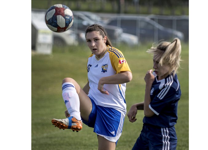 LEG RAISER – Andrea Holmes of the St. Albert Impact 1 team kicks the ball past Courtney Eliuk of Xavier Academy in Sunday's premier division match in the Edmonton District Soccer Association. The first loss after three wins for the Imapct (5-4), last year's provincial silver medallists, was 4-3 to Xavier (3-3-2) at Riel Park. Tuesday's score against Victoria 2 (2-6-2) in St. Albert was unavailable at press time.
DAN RIEDLHUBER/St. Albert Gazette

