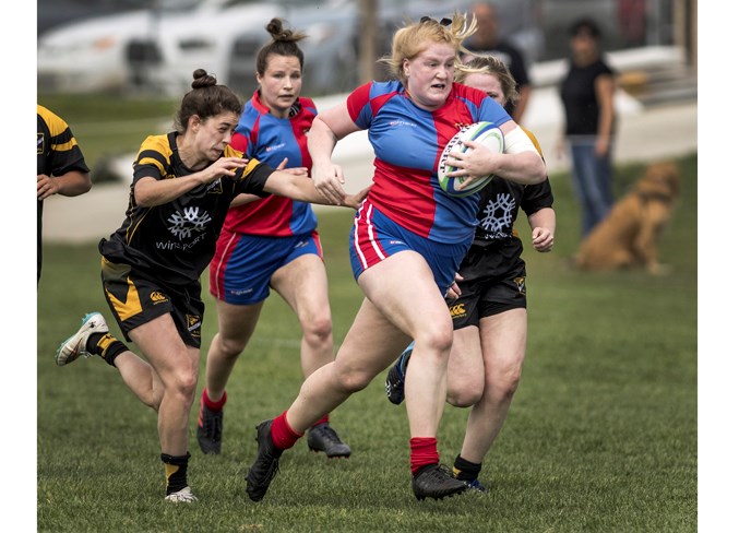 POWER DRIVEN – Sydney De La Mare of the St. Albert Rugby Football Club can't be stopped as Erica Kromm of the Calgary Hornets gives chase in the first half of the Alberta premier women's match Saturday at SARFC. Keeping up with the play is Jillian Ankutowicz of SARFC. De La Mare scored one of her three tries on this run, but despite the hat-trick performance SARFC lost 46-25. 
DAN RIEDLHUBER/St. Albert Gazette
