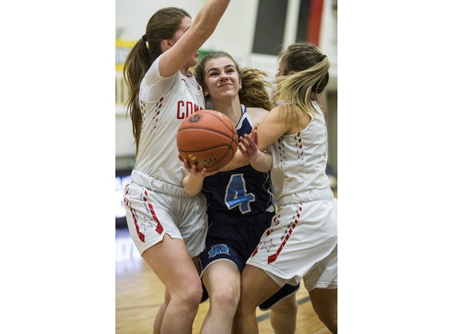 SURROUNDED – Chelsea Marko of the Paul Kane Blues is caught in a tight squeeze in Friday’s 53-52 win over the Raymond Comets at the 4A provincial high school championship at Jasper Place. Kayleena Garda potted the game-winning basket with 7.1 seconds remaining. The Blues finished 2-2 after Saturday’s 80-59 loss to the Centennial Coyotes of Calgary in the championship side of the provincial bracket in the 16-team tournament.
CHRIS COLBOURNE/St. Albert Gazette