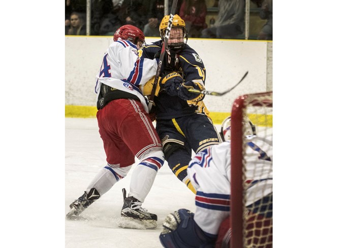 INTERFERENCE – Jaxon Dube of the St. Albert Nektar Raiders is hauled down while driving to the net by Carson Cox of the Fort Saskatchewan Rangers in the north division final of the Alberta Midget AAA Hockey League. The Raiders rallied from two overtime losses with three victories in a row, including Friday’s 3-2 double overtime thriller as Mathew Rathbone capitalized on the power play for the game winner at JRC Arena and Sunday’s 4-0 decision at Akinsdale Arena as Evan Fradette posted the shutout with 27 saves. The Raiders will now battle the Calgary Buffaloes in the best-of-five AMHL provincial final. Game one is 8:15 p.m. Friday in Calgary and game two is 3 p.m. Sunday at Akinsdale. 
DAN RIEDLHUBER/St. Albert Gazette