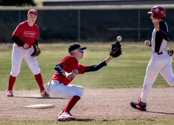 GLOVEMAN – Eric Machej attempts to field the ball with Ethan Revells heading to second base as Carter Liske backs up the play during Saturday's practice for the U15 AAA St. Albert Cardinals at Legion Memorial Park. The Cardinals host a pair of doubleheaders this weekend to start off league play. Saturday's game times are 12 noon against the Northwest Prairie Pirates and 6 p.m. against the Edmonton Expos. Sunday the Cardinals play the Pirates at 10 a.m. and the Expos at 4 p.m.
DAN RIEDLHUBER/St. Albert Gazette