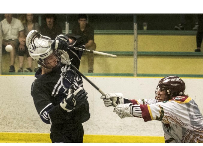 STICKED – Aaron Jones of the St. Albert Crude loses the ball while whacked by Tanner Lam of the Rockyview Silvertips of Cochrane in Saturday's junior B Tier I game in the Rocky Mountain Lacrosse League. The Crude won 13-7 at Akinsdale Arena. The Crude (12-3) are winners of eight straight and 10 of the last 11 games after beating the host Sherwood Park Outlaws 16-9 Sunday. 
DAN RIEDLHUBER/St. Albert Gazette