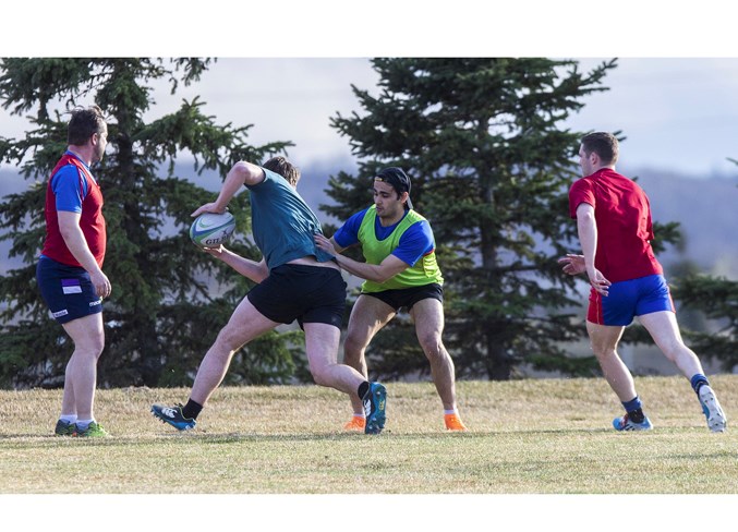 TRAINING SESSION – Jeff Sharma latches onto Cam Larson as Matt Jarvis, left, and Duncan Maguire look on during the the first outdoor practice for the men's program Tuesday at St. Albert Rugby Football Club. The season opener for the Labatt's Cup premier men's champions is May 25 against the Lep/Tigers at 1:30 p.m. at Ellerslie Rugby Park. The women's fixtures kick off Thursday with the Alberta premier match between SARFC and the visiting Pirates at 7 p.m.
CHRIS COLBOURNE/St. Albert Gazette