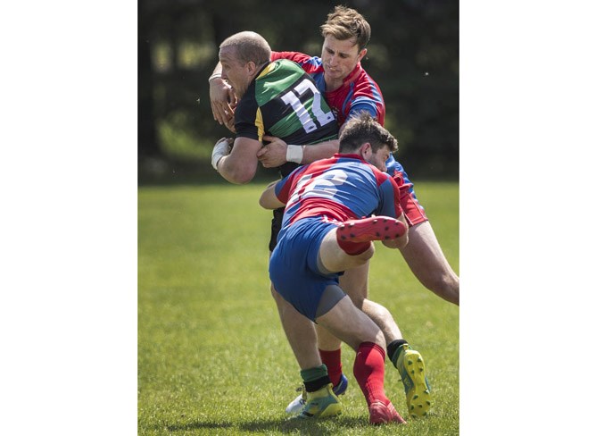 DOUBLE TROUBLE – Joe Casella, top, and Adam Bontus of the St. Albert Rugby Football Club  join forces to tackle Khaleb Whitehurst of the Lep/Tigers in Alberta Cup premier men's action Saturday at Ellerslie Rugby Club. The Lep/Tigers scored a converted try on the last play to knock off the Labatt's Cup provincial champions 20-18 in the first match of the season for both teams.
DAN RIEDLHUBER/St. Albert Gazette