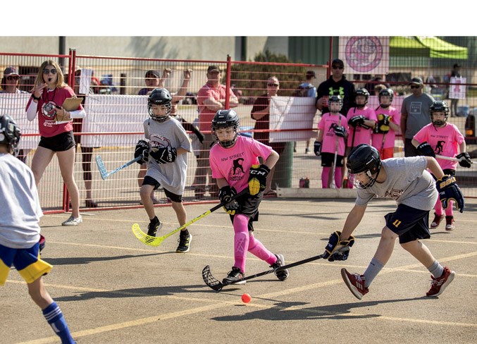 ROAD WARRIORS – The Canadians (grey) battle the Snipers (pink) in the boys' atom division at the seventh annual Road Rage Street Hockey Tournament at Servus Credit Union Place south parking lot Sunday. The weekend street hockey festival featured 800 registered players on 114 teams, including nine all-girls' teams that competed with the boys. A number of girls also played co-ed with the boys. Overall, 270 games were staged in six age divisions. The Road Rage tournament was founded by St. Albert hockey enthusiasts' Rob Brown, Geoff Giacobbo, Rob LeLacheur and Dave Ridd.
DAN RIEDLHUBER/St. Albert Gazette