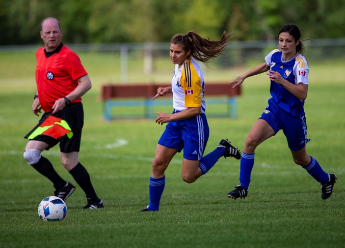 CHASERS – Alyson Katerenchuk, left, of St. Albert Impact 3 and Ava Bourbonnais of St. Albert Impact 2 track down the ball in Sunday's premier division match in the Edmonton District Soccer Association. Impact 2 won 2-1 at Riel Park.
CHRIS COLBOURNE/St. Albert Gazette