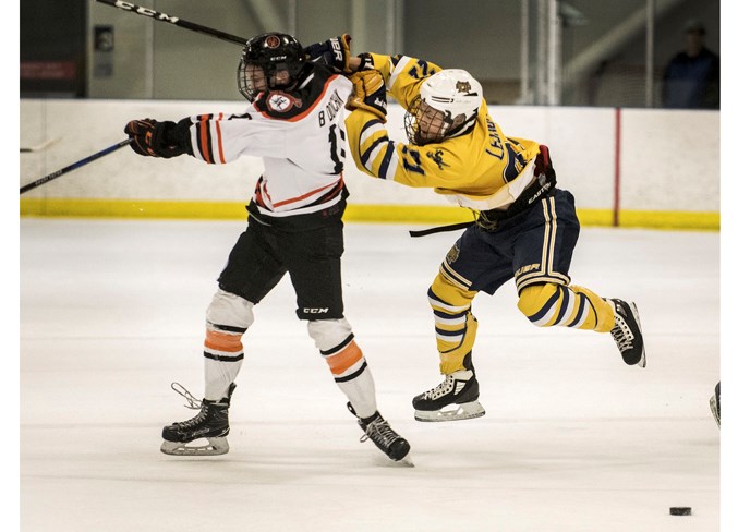 CLOSE CALL – Preston Leung of the St. Albert Source for Sports Crusaders slips past an open-ice hit by Brady Dovichak of the Medicine Hat Hounds at the midget AA provincials last weekend. The Crusaders finished 4-1 as bronze medallists and two of the victories were against the Camrose Vikings by scores of 5-1 in the round robin and 4-1 in the playoffs. The two teams faced off Thursday in the best-of-five series opener in the Northern Alberta Midget AA Hockey League final and the Crusaders won 3-2 in overtime at Akinsdale Arena. Tanvir Grewal tied it at two with one second left in regulation time and Ethan Pool potted the winner at 7:17 of OT. Game two is 6 p.m. tonight in Camrose and game three is 7:15 p.m. Monday at Go Auto Arena. The Crusaders are the defending league champions.
DAN RIEDLHUBER/St. Albert Gazette