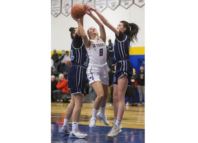 TWO ON ONE – Kyleigh Kornak of the St. Albert Skyhawks is double-teamed in the paint by Kayleena Garda, right, and Ella Stanley of the Paul Kane Blues in the metro Edmonton division one league. The 4A provincials tip off Thursday for both teams and in the round of 16, the No. 1-ranked Skyhawks (13-0 as repeat winners of the division one championship and 26-5 overall), host the No. 16 Charles Spencer Mavericks of Grande Prairie at 11 a.m. and the No. 10 Paul Kane Blues (9-3 in division one and 18-9 overall) welcome the No. 7 Magrath Pandas at 9 a.m. The remaining games for the Skyhawks and Paul Kane, including a second game on Thursday, will be played at Jasper Place High School. Visit www.asaa.ca for the provincial draw.
CHRIS COLBOURNE/St. Albert Gazette