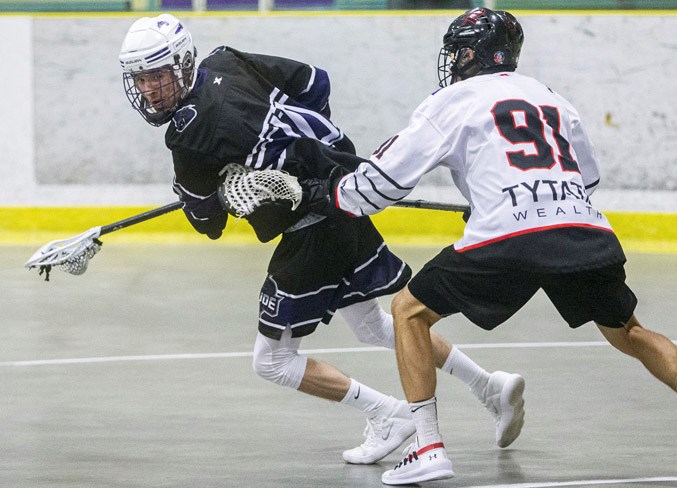 KEEP AWAY – Aaron Jones of the St. Albert Crude attempts to spin away from Jordan Diewert of the Fort Saskatchewan Rebels in the junior B Tier I playoff series in the Rocky Mountain Lacrosse League. The third and deciding game in the north division final ended with the Crude losing 10-8 Tuesday at JRC Arena. The Crude forced a third game with Monday's 14-12 overtime decision at Akinsdale Arena after dropping game one 8-7 Sunday in the Fort. The Crude finished 18-6-1 overall after placing second at 15-4-1 behind the Rebels (15-3-2) by one point in the north standings.
CHRIS COLBOURNE/St. Albert Gazette