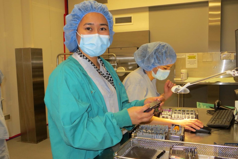 Medeleine Gabasa (front) takes point while working alongside colleague Xu Qian (back) at the Sturgeon Hospital's medical device reprocessing centre. ANNA BOROWIECKI/Photo