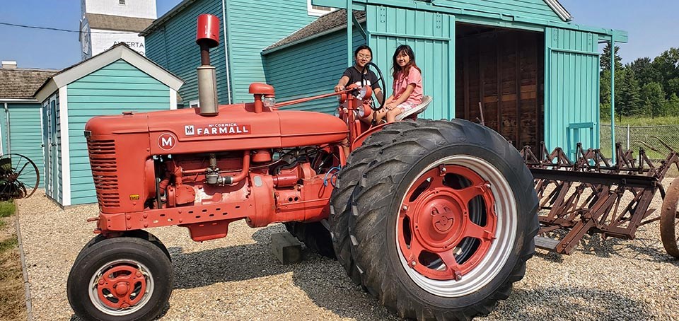 farm-equipment-in-front-of-one-grain-elevator