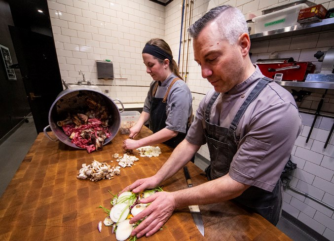 USE YOUR SCRAPS – RGE RD chef de cuisine Davina Moraiko and chef Blair Lebsack use scrap vegetables and meat to create stock and broth for some of the restaurant’s dishes. Reducing food waste can significantly shrink the carbon footprint of your diet. 
CHRIS COLBOURNE/St. Albert Gazette