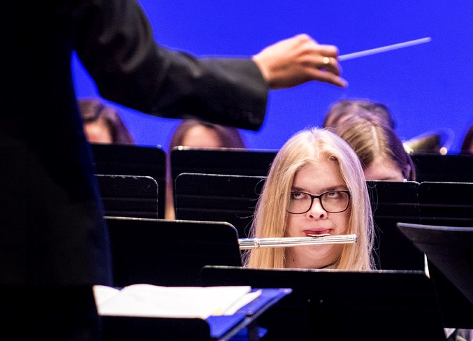 A member of the Sturgeon Composite High School band looks up at conductor Kyle Swenson as she plays a flute in the Concert Band competition of the annual Rotary Music Festival at the Arden Theatre in St. Albert on Wednesday, April 10. 
DAN RIEDLHUBER/St. Albert Gazette