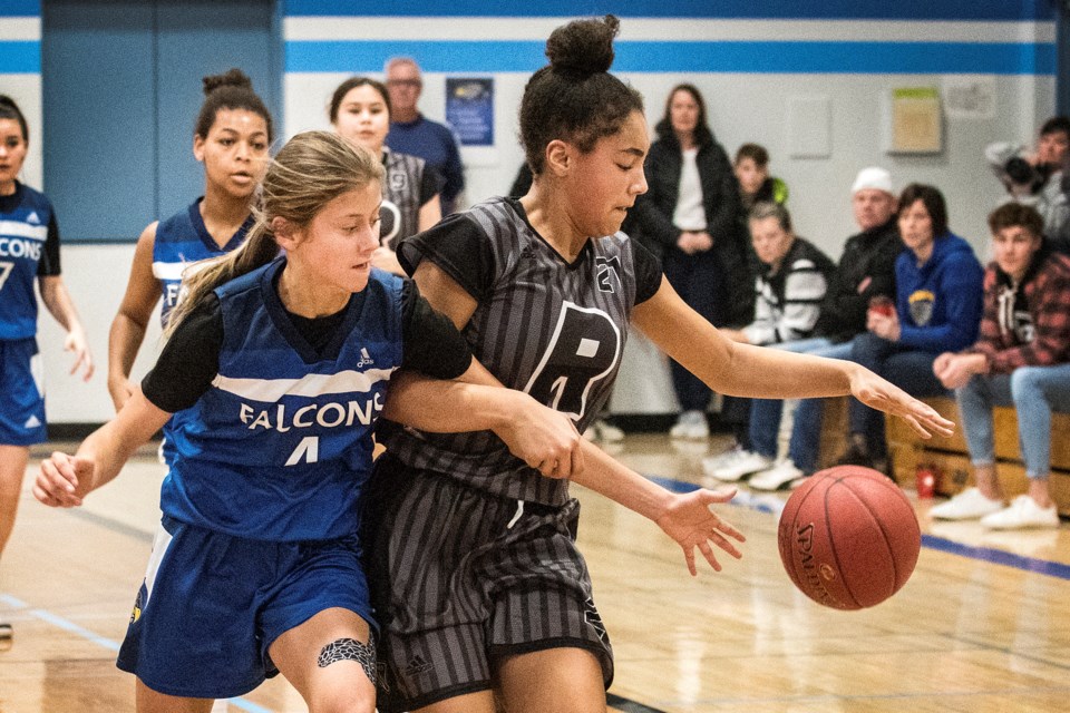 REACHING IN – Claudia Holt of the Richard S. Fowler Falcons takes a stab at the ball while defending against Victoria Davson of the Vimy Ridge Academy Raiders in Saturday's final at the Fowler Classic. The Falcons won 73-42 for their fifth consecutive Fowler Classic title. The six-team girls' and boys' draws included the Vincent J. Maloney Marauders placing third overall for the girls and boys. The Falcons also beat Vimy Ridge in the boys' final 76-53.
DAN RIEDLHUBER/St. Albert Gazette