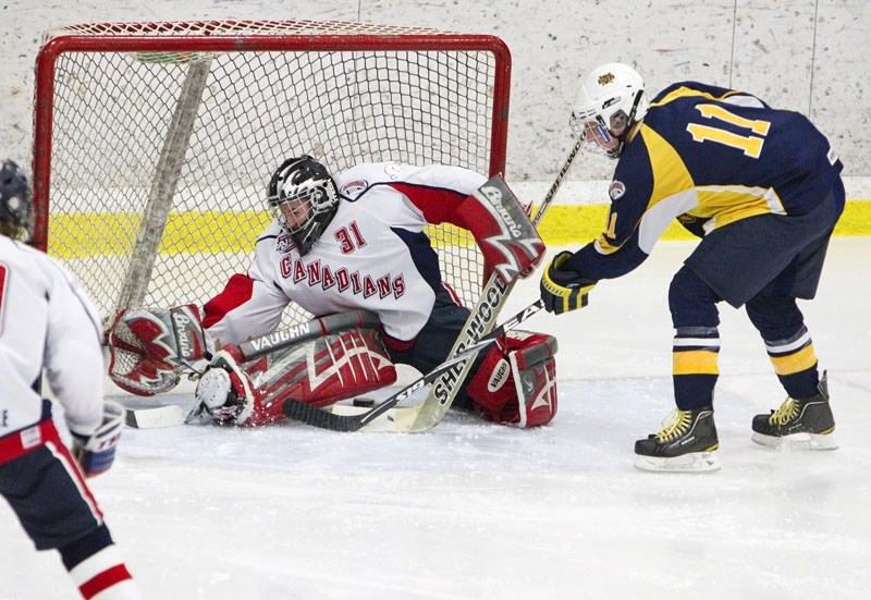 Braeden Farge slides the puck under CAC United Cycle netminder Theodore Zubot in the last game for the St. Albert Flyers before the Christmas break in the Alberta Minor