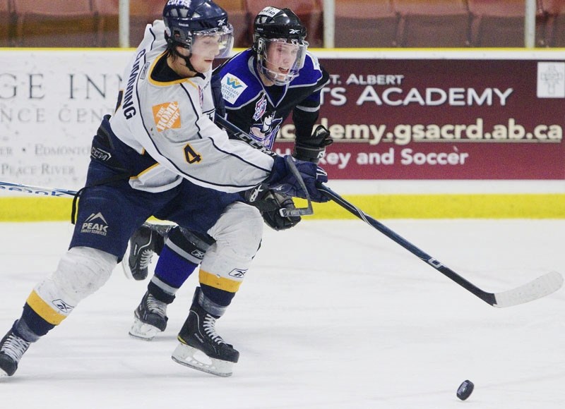 Ryan Berlin of the St. Albert Steel battles for the puck against Matt Cumming of the Grande Prairie Storm in Monday&#8217;s AJHL game at Performance Arena. The Steel