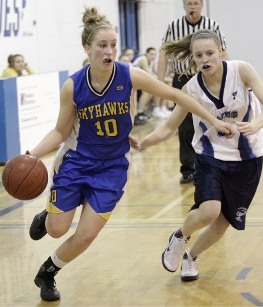 Shelby Hucul of the St. Albert Skyhawks dribbles away from Josee Larson of the Paul Kane Blues in Monday&#8217;s premier women&#8217;s tilt at Paul Kane High School. The