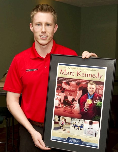 Olympic gold medallist Marc Kennedy displays the gift he received from the City of St. Albert