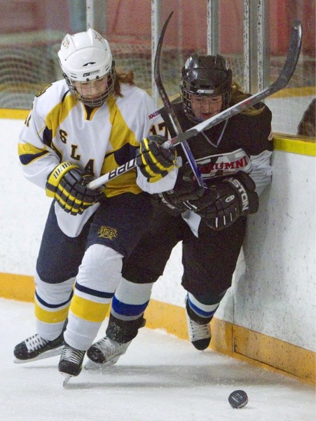 Haley Kuzyk of the St. Albert Slash battles for the puck along the boards against the Edmonton Thunder in Sunday&#8217;s female midget AAA contest at Castledowns Arena. The