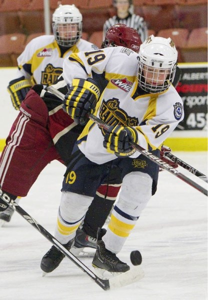 Matteo Gennaro of the St. Albert Sabres works the puck up ice against the Phoenix Junior Coyotes at the John Reid Memorial Tournament. Brett Smythe scored twice in