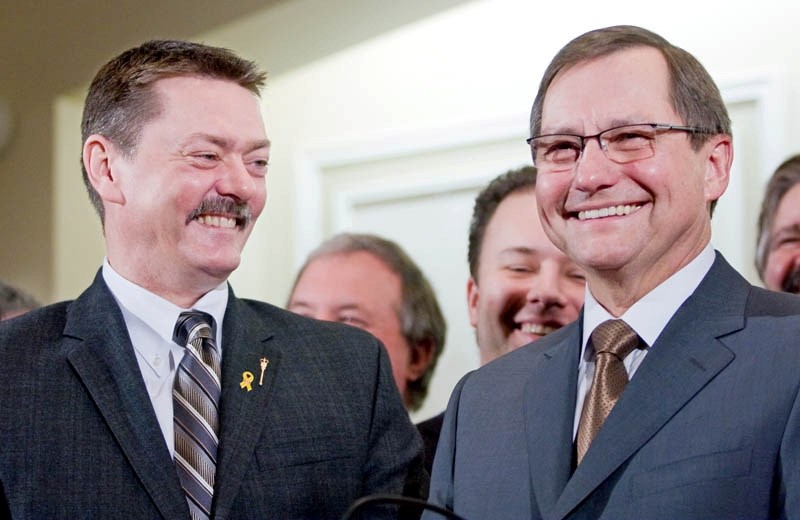Deputy Premier Doug Horner (left) shares a laugh with Premier Ed Stelmach following his swearing in as deputy premier in January 2010.