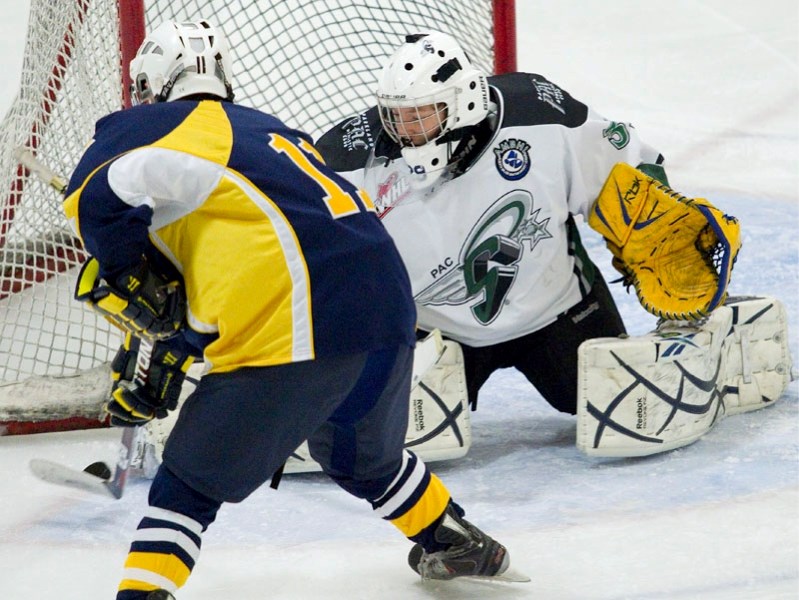 Brett Smythe of the St. Albert Sabres is stymied by Spruce Grove PAC Saints&#8217; goalie J.T. Bartlett during second period action in Saturday&#8217;s quarter-final playoff