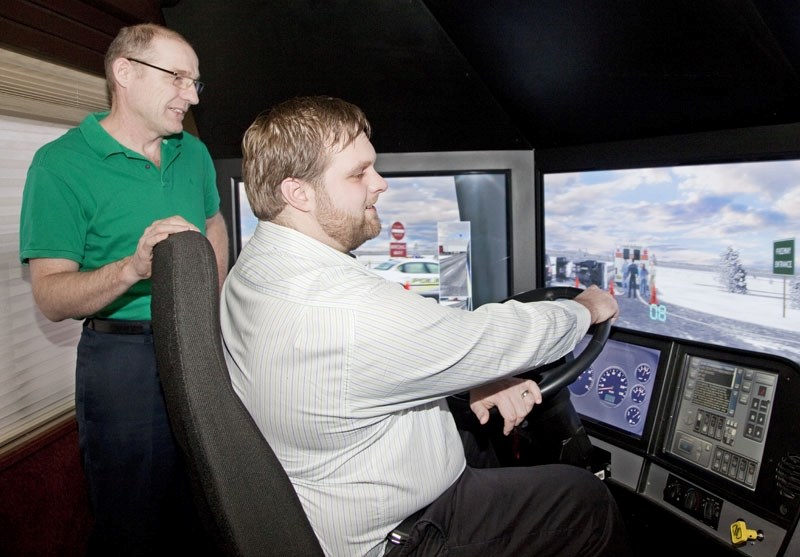 Mobile Training Unit (MTU) lead instructor Race Dixon (left) watches the progress of Cameron Adam